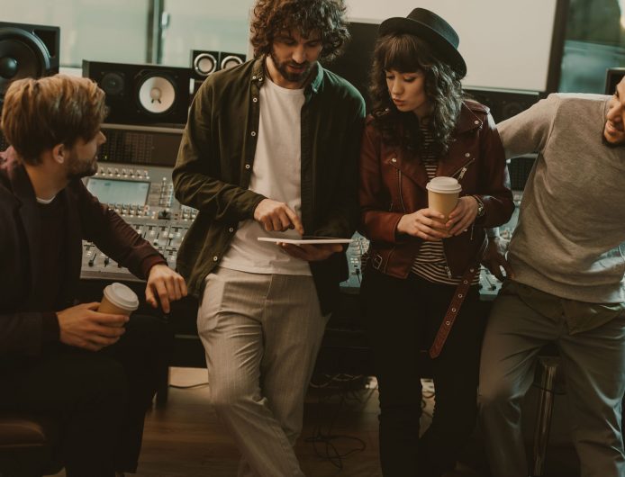 music band having conversation at sound recording studio